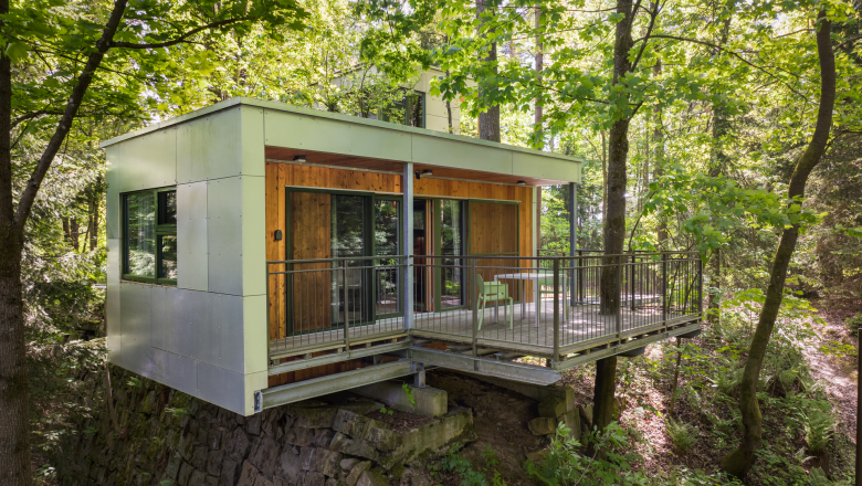 Modern tree house with terrace in the forest.
